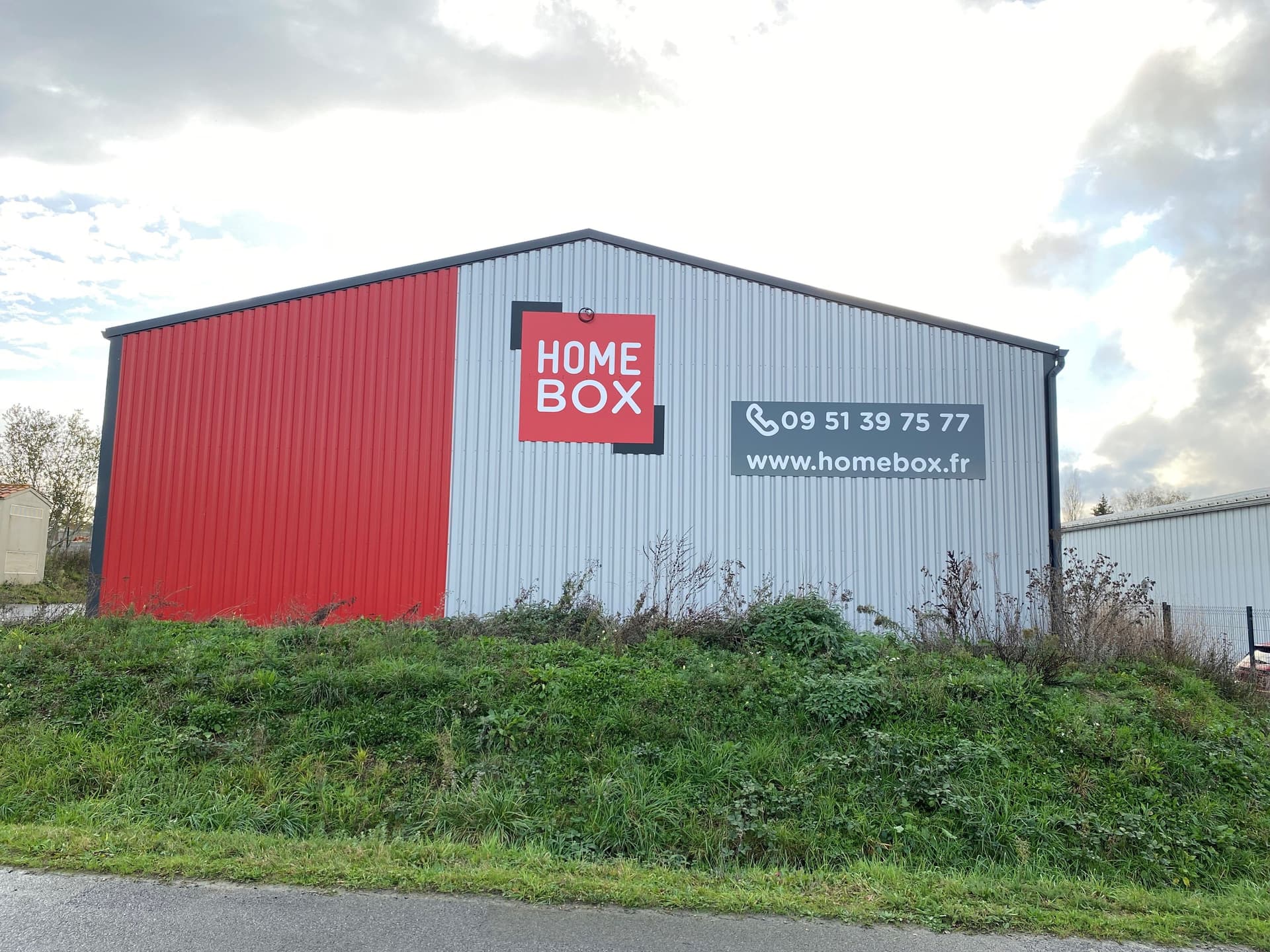 Façade latérale avec logo HOMEBOX et panneau d’informations au centre HOMEBOX Bressuire.