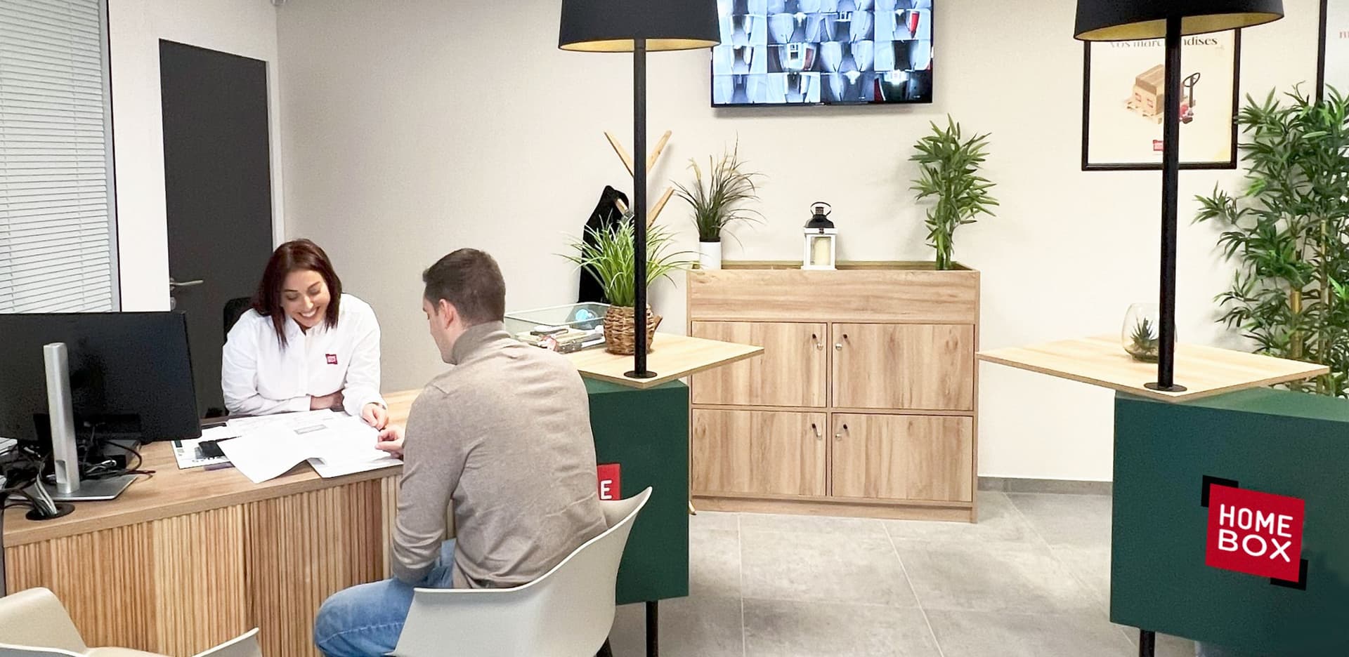 Conseillère accueillant un client au comptoir d'accueil du centre HOMEBOX Lyon Craponne